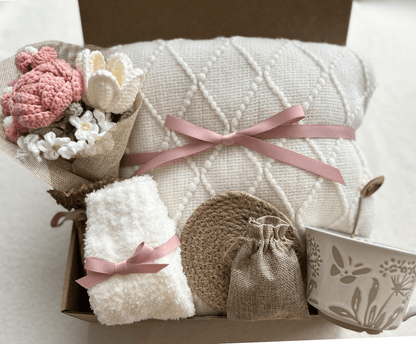Care package gift basket for women with knitted blanket, floral mug, socks and crochet flower bouquet - Basketful Gifts